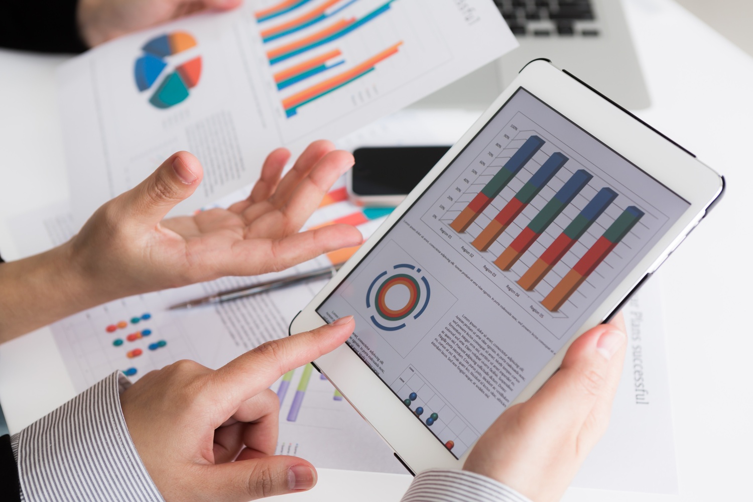 close-up-business-team-using-digital-tablet-with-financial-d (1).jpg